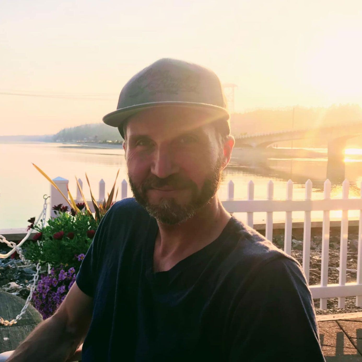 Ethan, smiling by the water at sunset